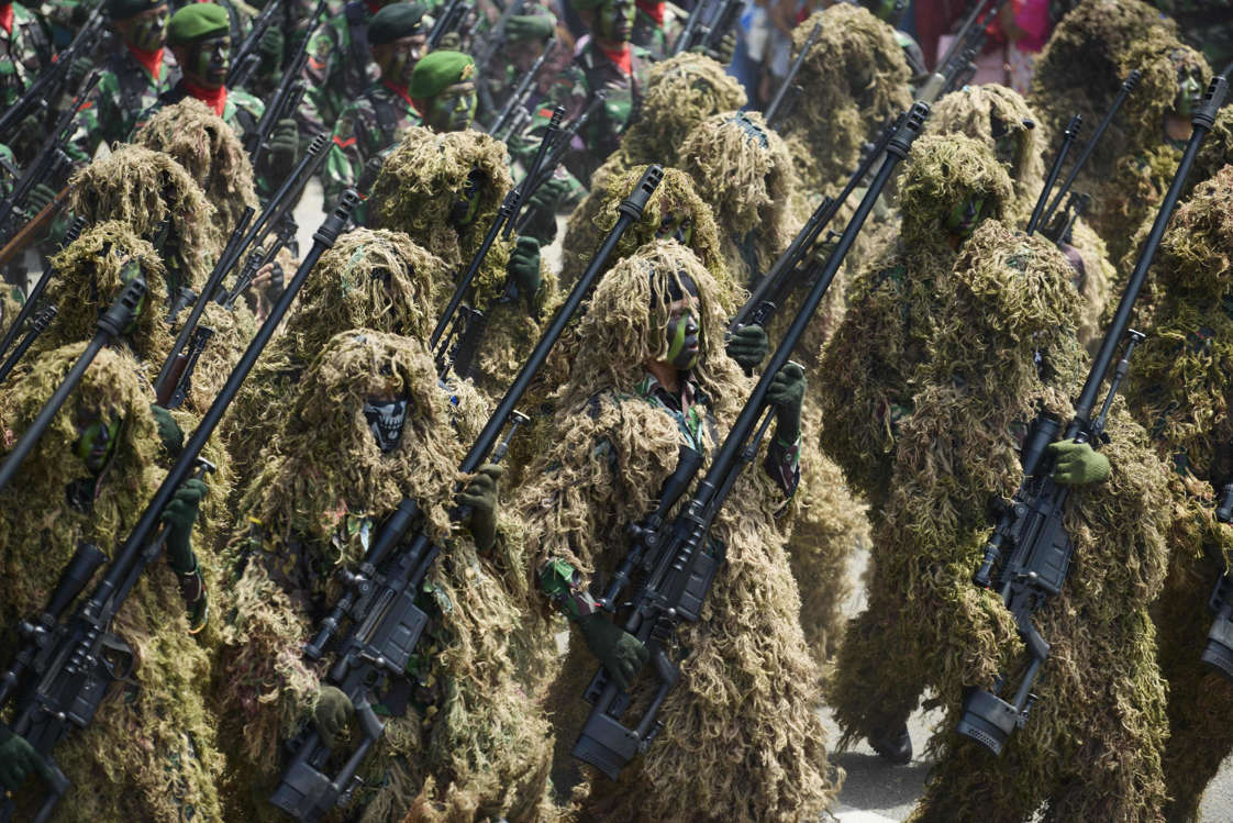 Slide 36 of 51: Indonesian soldiers march during a parade to mark the 72nd anniversary of the Indonesian military's founding, in Banda Aceh on October 5, 2017. / AFP PHOTO / CHAIDEER MAHYUDDIN (Photo credit should read CHAIDEER MAHYUDDIN/AFP/Getty Images)