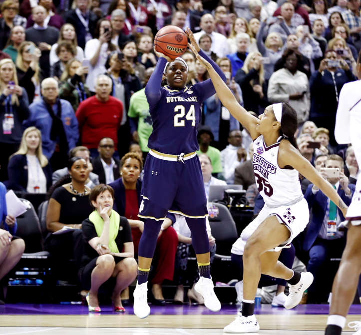 Slide 4 of 97: Arike Ogunbowale (24) of Notre Dame hits the game winning shot with 0.1 seconds remaining in the fourth quarter under pressure from Victoria Vivians (35) to defeat Mississippi State 61-58 in the championship game of the 2018 NCAA Women's Final Four on April 1, in Columbus, Ohio.