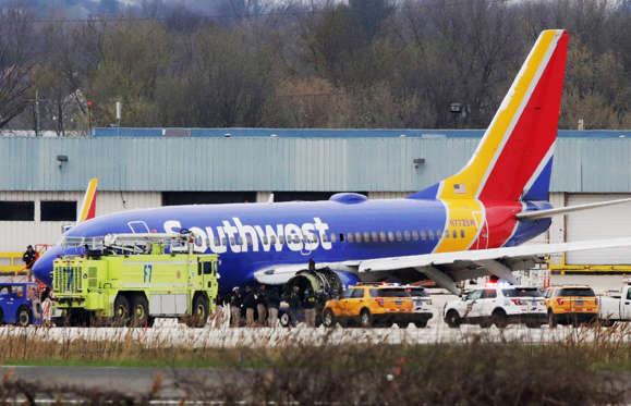 Slide 1 of 6: A Southwest Airlines jet sits on the runway at Philadelphia International Airport after it was forced to land with an engine failure, in Philadelphia, Pennsylvania, on April 17, 2018. A catastrophic engine failure on a Southwest Airlines flight from New York to Dallas killed one person and forced an emergency landing in Philadelphia on Tuesday in a terrifying ordeal for passengers.