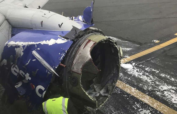 Slide 4 of 6: The engine on a Southwest Airlines plane is inspected as it sits on the runway at the Philadelphia International Airport after it made an emergency landing in Philadelphia, Tuesday, April 17, 2018.