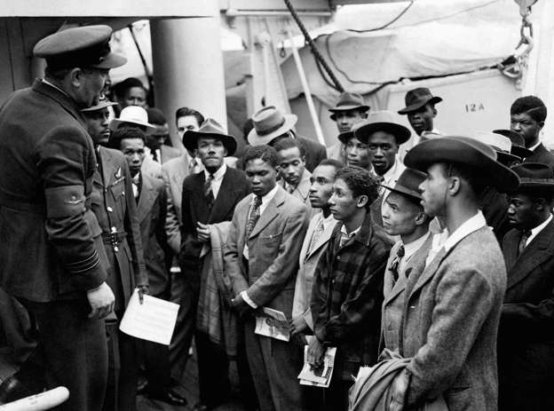 File photo 22/06/1948 of Jamaican immigrants welcomed by RAF officials from the Colonial Office after the ex-troopship HMT 'Empire Windrush' landed them at Tilbury.
