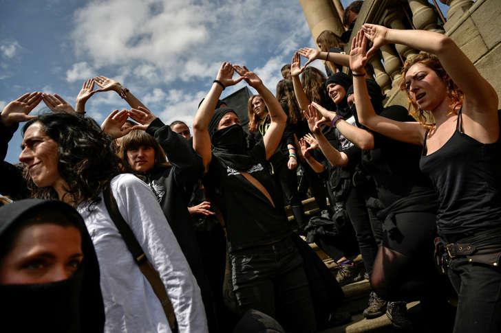 Masked women shout slogans during a protest against sexual abuse in Pamplona, northern Spain, Saturday, April 28, 2018. Women's rights groups protest after a court in Pamplona sentenced five men to nine years each in prison for sexual abuse in what activists saw as a gang rape during the 2016 running of the bulls festival in Pamplona. (AP Photo/Alvaro Barrientos)