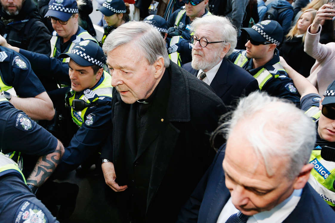 MELBOURNE, AUSTRALIA - JULY 26:  Cardinal George Pell walks with a heavy Police guard to the Melbourne Magistrates' Court on July 26, 2017 in Melbourne, Australia. Cardinal Pell was charged on summons by Victoria Police at Melbourne Magistrates' Court on July 26, 2017 in Melbourne, Australia. Cardinal George Pell was charged on summons by Victoria Police on 29 June over multiple allegations of sexual assault. Cardinal George Pell is Australia's highest ranking Catholic and the third most senior Catholic at the Vatican, where he was responsible for the church's finances. Cardinal George Pell has leave from his Vatican position while he defends the charges.  (Photo by Michael Dodge/Getty Images)