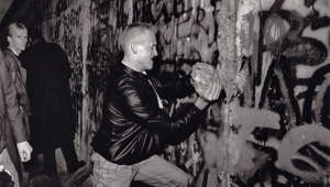 November 11, 1989: A youth takes a large piece of the Berlin Wall in his hands as he tries to hammer a hole in the wall with it. Washington Post photo by Rich Lipski.