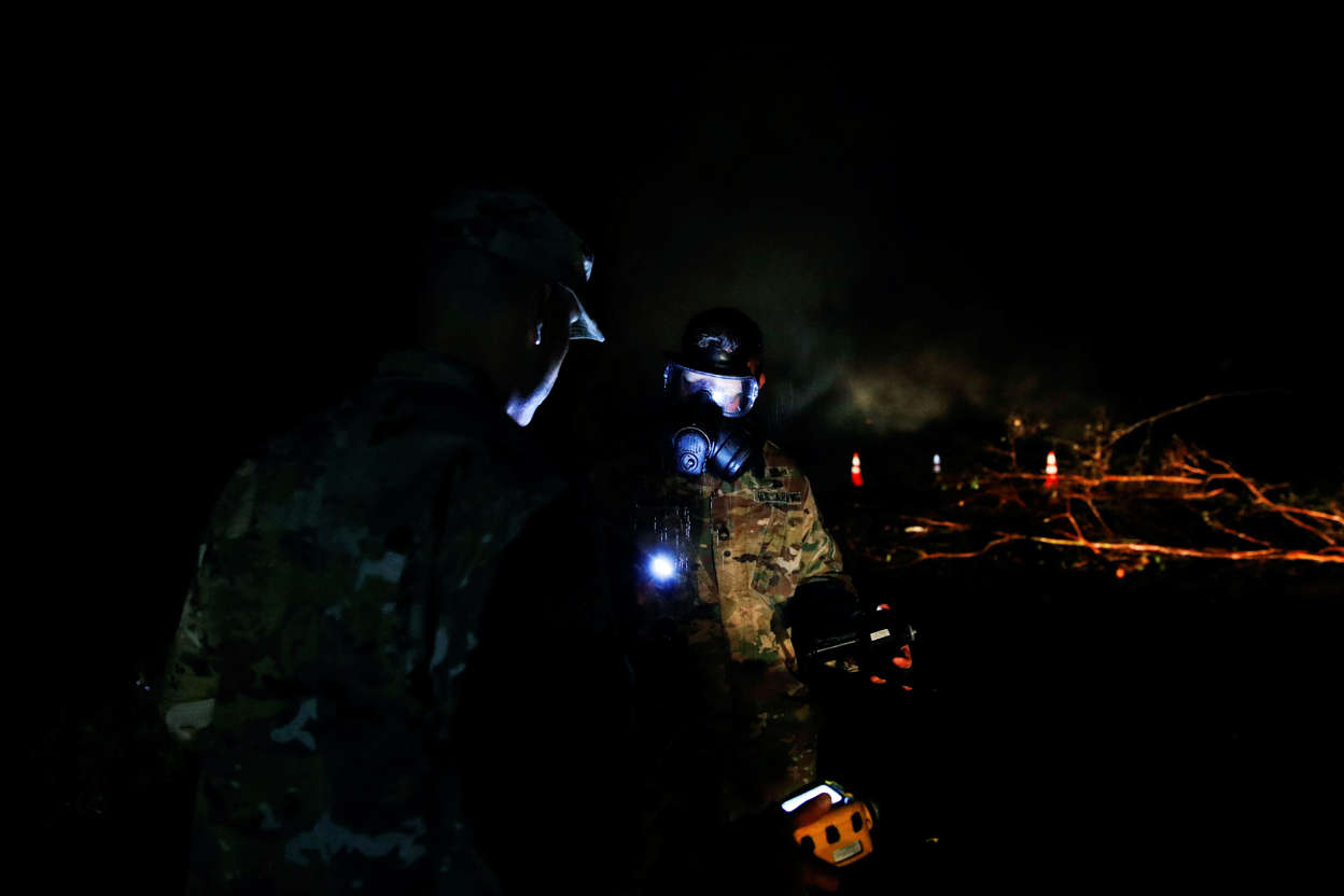 Slide 1 of 105: First Lt. Aaron Hew Len, left, and Sgt. 1st Class Carl Satterwaite, of the U.S. National Guard, test air quality near cracks emitting volcanic gases from a lava flow in the Leilani Estates subdivision near Pahoa, Hawaii on Thursday, May 10, 2018. Kilauea has destroyed more than 35 structures since it began releasing lava from vents about 25 miles (40 kilometers) east of the summit crater. (AP Photo/Jae C. Hong)