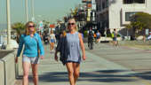 a woman walking down the street: How Walking Can Save You Money