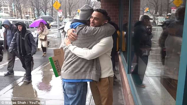a group of people walking in the rain: The pair share another warm embrace after Jay's unselfish acts of kindness and generosity
