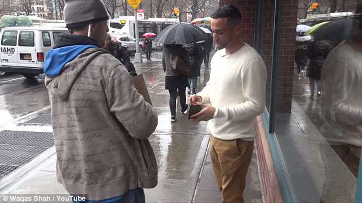 a man that is standing in the rain: At hearing his heartbreaking story, he is given yet more money for his kindness