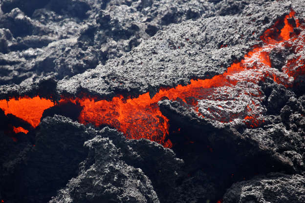 Slide 20 of 111: Lava erupts from a fissure east of the Leilani Estates subdivision during ongoing eruptions of the Kilauea Volcano in Hawaii, U.S., May 12, 2018.
