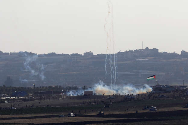 A smoke from the tear gas fired by Israeli troops can be seen from the Israeli side of the border be... - Amir Cohen/Reuters Slide 6 of 60: A smoke from the tear gas fired by Israeli troops can be seen from the Israeli side of the border between Israel and Gaza, at the northern Gaza Strip, May 14, 2018. REUTERS/Amir Cohen