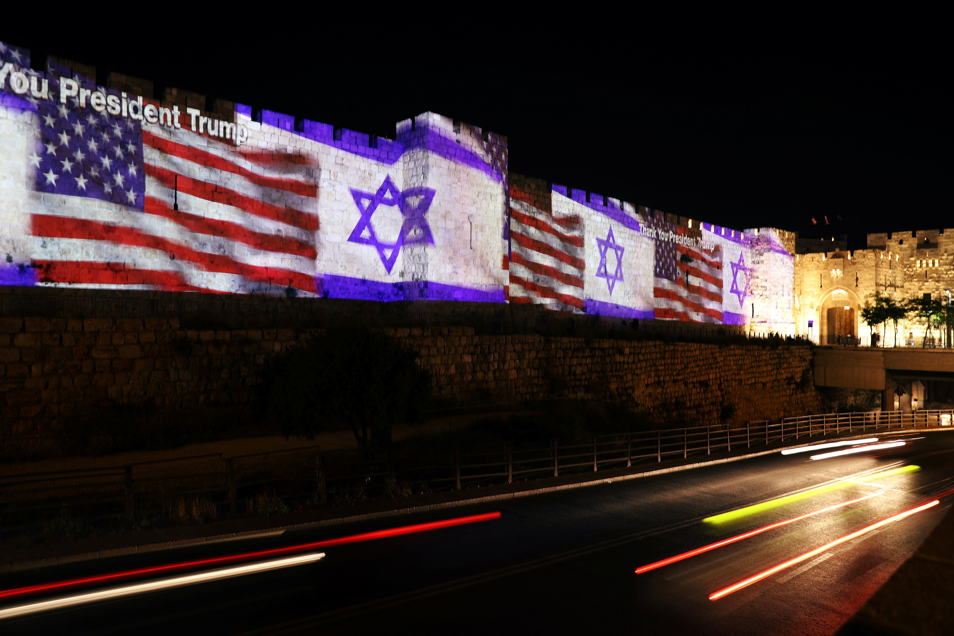 Slide 1 of 81: The U.S. and Israeli national flags are projected on a part of the walls surrounding Jerusalem's Old City, Israel May 14, 2018. REUTERS/Ammar Awad