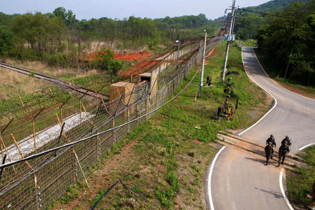 NothKoreaUSTension - Yonhap/EPA-EFE/REX/Shutterstock Slide 2 of 138: SOUTH KOREA OUT Mandatory Credit: Photo by YONHAP/EPA-EFE/REX/Shutterstock (9671387a) South Korean soldiers walk over the tracks of the Gyeongui railway, blocked by a barbed wire fence, inside the Demilitarized Zone (DMZ) separating the two Koreas at the western section of the inter-Korean border in Paju, South Korea, 15 May 2018. The leaders of South and North Korea agreed to link cross-border roads and railways on 27 April when they held the historic inter-Korean summit at the truce village of Panmunjom inside the DMZ, raising prospects for South Korea's project to build a railway connection with North Korea. Agreement on cross-border roads and railways for South and North Korea, Paju - 15 May 2018