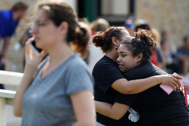 Slide 1 of 6: Santa Fe High School junior Guadalupe Sanchez, 16, cries in the arms of her mother, Elida Sanchez, after reuniting with her at a meeting point at a nearby Alamo Gym fitness center following a shooting at Santa Fe High School in Santa Fe, Texas, on Friday, May 18, 2018. (Michael Ciaglo/Houston Chronicle via AP)