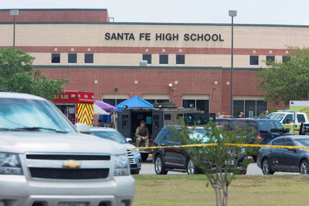 Slide 1 of 23: Emergency crews gather in the parking lot of Santa Fe High School where at least eight people were killed on May 18, 2018 in Santa Fe, Texas. - At least eight people were killed when a student opened fire at his Texas high school on May 18, 2018, as President Donald Trump expressed "heartbreak" over the latest deadly school shooting in the United States. The shooting took place as classes were beginning for the day at Santa Fe High School in the city of the same name, located about 30 miles (50 kilometers) southeast of Houston."There are multiple fatalities," Harris County Sheriff Ed Gonzalez told reporters. "There could be anywhere between eight to 10, the majority being students." (Photo by Daniel KRAMER / AFP)        (Photo credit should read DANIEL KRAMER/AFP/Getty Images)