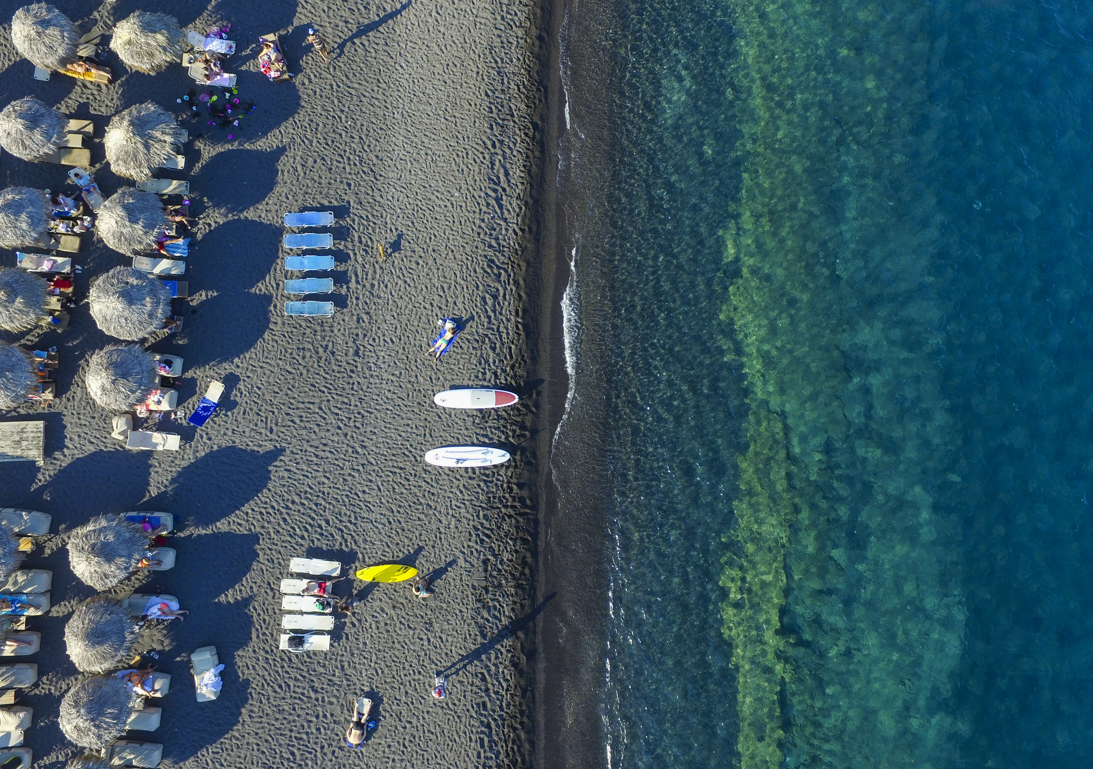 Slide 37 of 39: SANTORINI, GREECE - JUNE 30: Aerial view of Perissa beach on June 30, 2015 in Santorini, Greece. Perissa is a village on the island of Santorini and located 13 km to the southeast of Fira. (Photo by Athanasios Gioumpasis/Getty Images)
