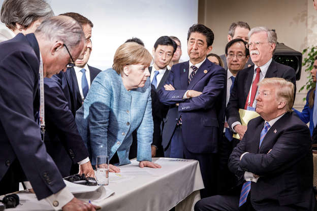 German Chancellor Angela Merkel speaks to U.S. President Donald Trump during the second day of the G7 meeting in Charlevoix city of La Malbaie, Quebec, Canada, June 9, 2018.