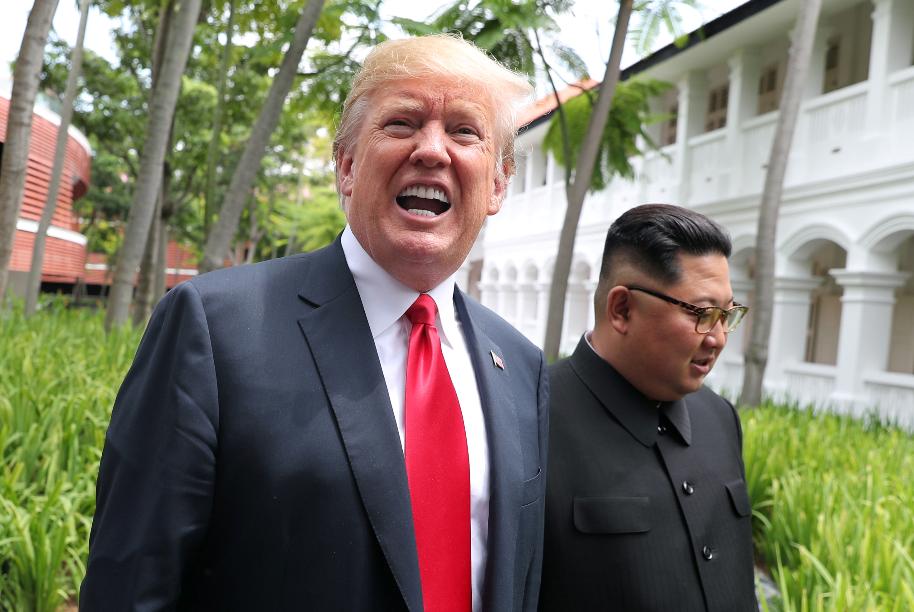 U.S. President Donald Trump and North Korean leader Kim Jong Un walk after lunch at the Capella Hotel on Sentosa island in Singapore June 12, 2018. REUTERS/Jonathan Ernst