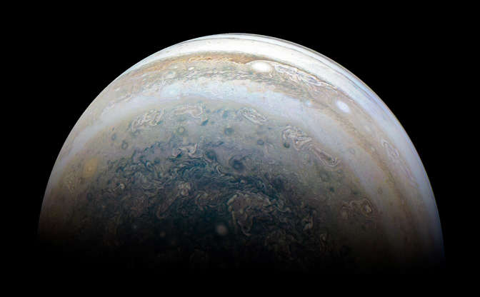 Slide 3 of 86: The color-enhanced image was taken at 11:31 p.m. PDT on May 23, 2018 (2:31 a.m. EDT on May 24), as the spacecraft performed its 13th close flyby of Jupiter. At the time, Juno was about 44,300 miles (71,400 kilometers) from the planet's cloud tops, above a southern latitude of 71 degrees.