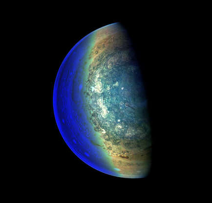 Slide 4 of 81: This image captures the swirling cloud formations around the south pole of Jupiter, looking up toward the equatorial region.