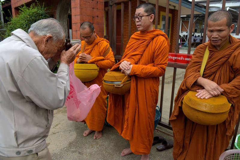 A Thai man prays to Buddhist monks near the hospital where the boys rescued after being trapped in a nearby cave for nearly two weeks have being brought for observation, in the northern Thai city of Chiang Rai on July 9, 2018. - Four boys among the group of 13 trapped in a flooded Thai cave for more than a fortnight were rescued on July 8 after surviving a treacherous escape, raising hopes elite divers would also save the others soon. (Photo by TANG CHHIN Sothy / AFP)        (Photo credit should read TANG CHHIN SOTHY/AFP/Getty Images)