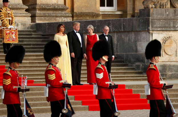 Slide 4 of 29: British Prime Minster Theresa May and her husband Philip stand together with U.S. President Donald Trump and First Lady Melania Trump at the entrance to Blenheim Palace, where they are attending a dinner with specially invited guests and business leaders, near Oxford, Britain, July 12, 2018. REUTERS/Kevin Lamarque
