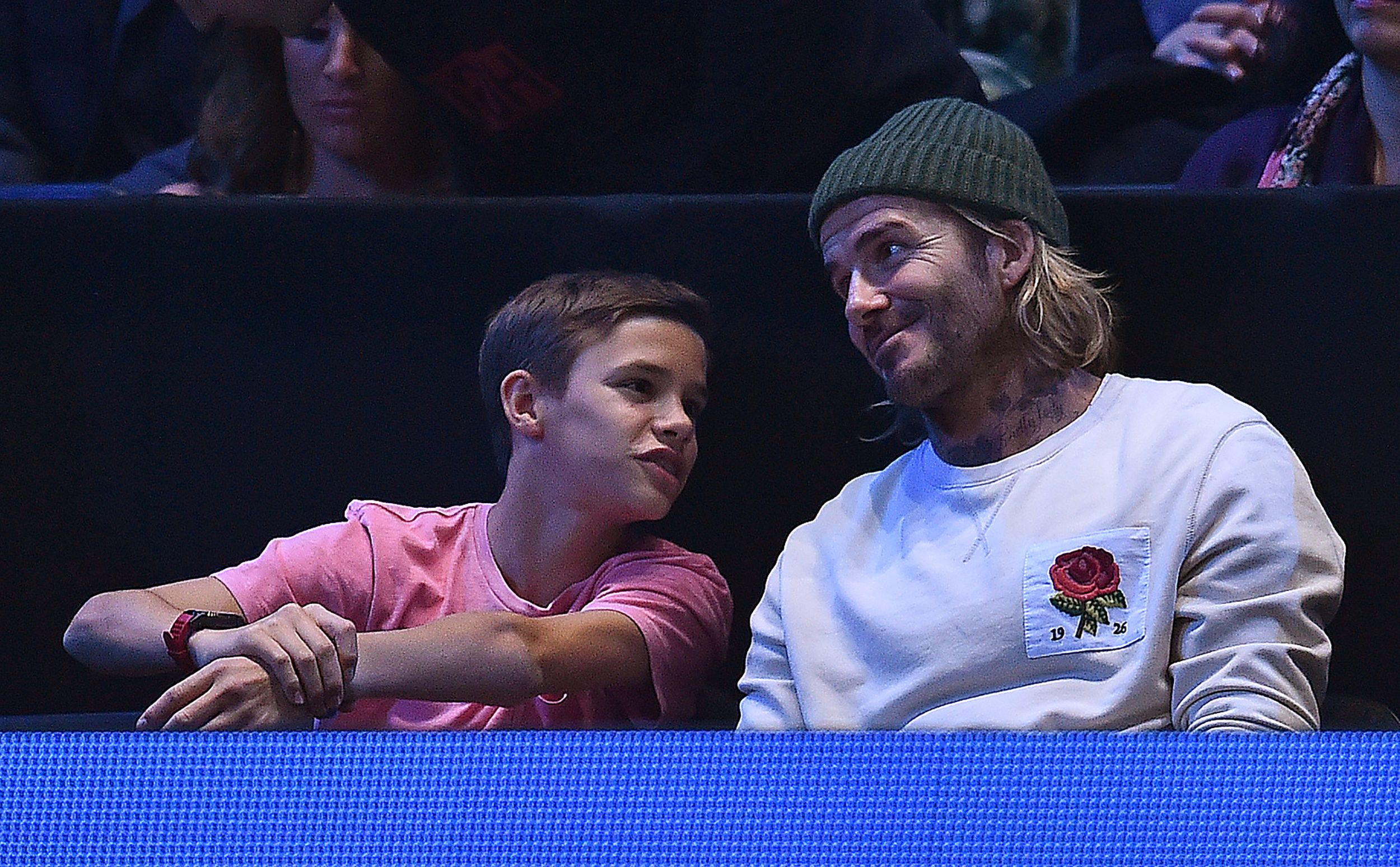 Slide 7 of 38: Former England international football player David Beckham (R), and his son Romeo, watch as Bulgaria's Grigor Dimitrov returns to Belgium's David Goffin during their men's singles final match on day eight of the ATP World Tour Finals tennis tournament at the O2 Arena in London on November 19, 2017. / AFP PHOTO / Glyn KIRK        (Photo credit should read GLYN KIRK/AFP/Getty Images)