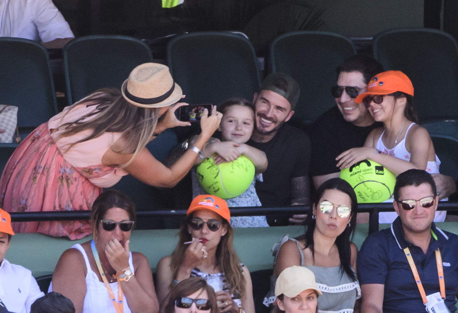 Slide 4 of 38: KEY BISCAYNE, FL - APRIL 01: David Beckham and his daughter  Harper pose for a photo while watching John Isner of the USA against  Alexander Zverev of Germany  in the men's final on Day 14 of the Miami Open Presented by Itau at Crandon Park Tennis Center on April 01, 2018 in Key Biscayne, Florida. (Photo by Mike Frey/Getty Images)