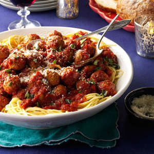 a plate of food on a table: One of my favorite childhood memories is going to the Old Spaghetti Factory with my family and ordering a big plate of cheesy spaghetti, meatballs and garlic bread. My homemade recipe reminds me of those fun times and satisfies everyone's craving for good Italian food. —Erika Monroe-Williams, Scottsdale, Arizona Get Recipe