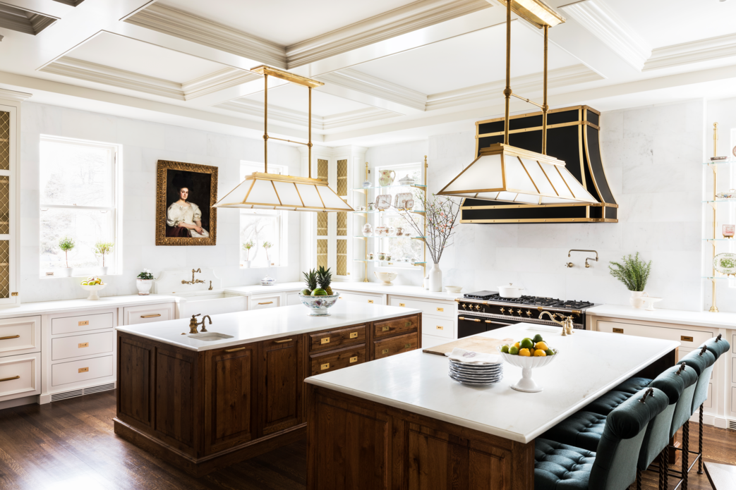 <p>Clean marble walls and glossy coffered ceilings make this Connecticut kitchen by designer <a href="https://www.scwinteriors.com/">Shazalynn Cavin-Winfrey</a> an airy spot to host a lively crowd. The double islands and overhead lighting (Ralph Lauren Home) add a sense of symmetry and balance to the large cook space. </p>