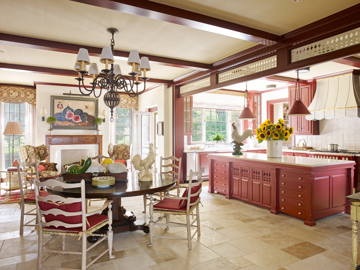 <p>In this 1850 Pennsylvania farmhouse kitchen and breakfast room, designer <a href="https://www.richardkeithlangham.com/">Richard Keith Langham</a> painted the cabinetry a juicy berry shade (Raisin Torte by <a href="https://www.benjaminmoore.com/en-us/color-overview/find-your-color/color/2083-10/raisin-torte?color=2083-10">Benjamin Moore</a>), adding exuberance back into the historic home. Ladder chairs from <a href="https://www.howe.com/us">Howe</a> surround a 19th-century elm table purchased in the Cotswolds. White backsplash tile by <a href="https://www.annsacks.com/">Ann Sacks</a> draws attention to the polished stove from <a href="https://ilveappliances.com/">Ilve</a>. </p>