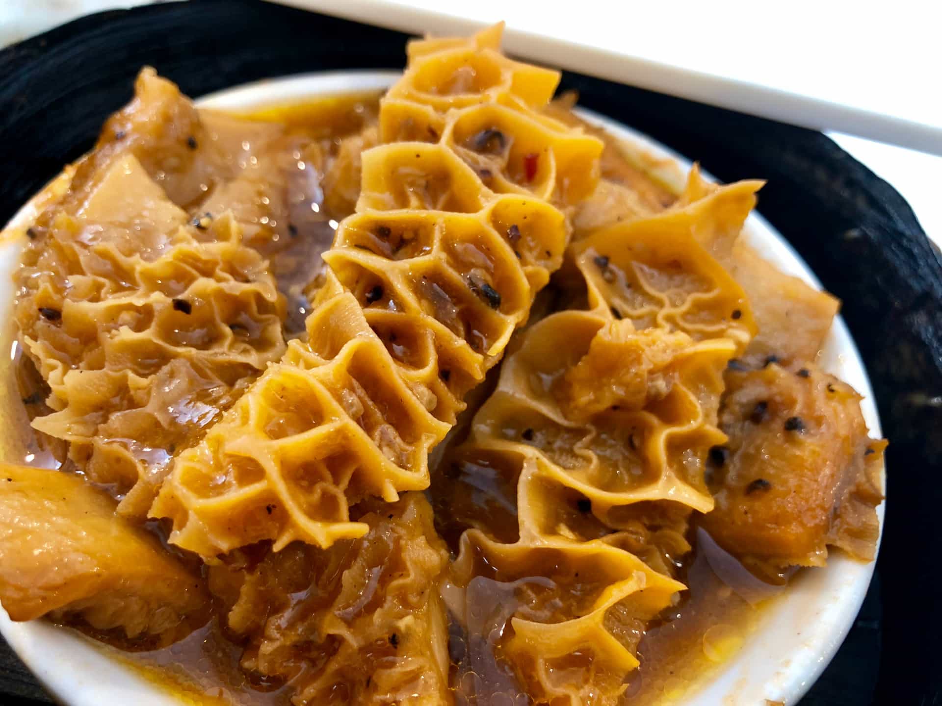 a close up of a plate of pasta with sauce and cheese