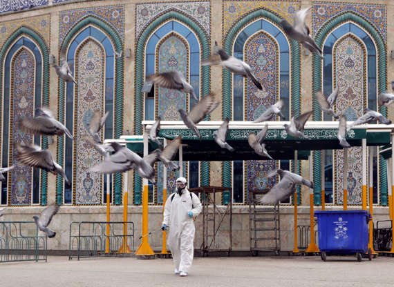 Slide 1 of 154: A worker in a protective suit sprays disinfectants near Imam Abbas shrine as a precaution against the coronavirus, following the outbreak, in the holy city of Kerbala, Iraq March 15, 2020.REUTERS/Abdullah Dhiaa Al-deen     TPX IMAGES OF THE DAY