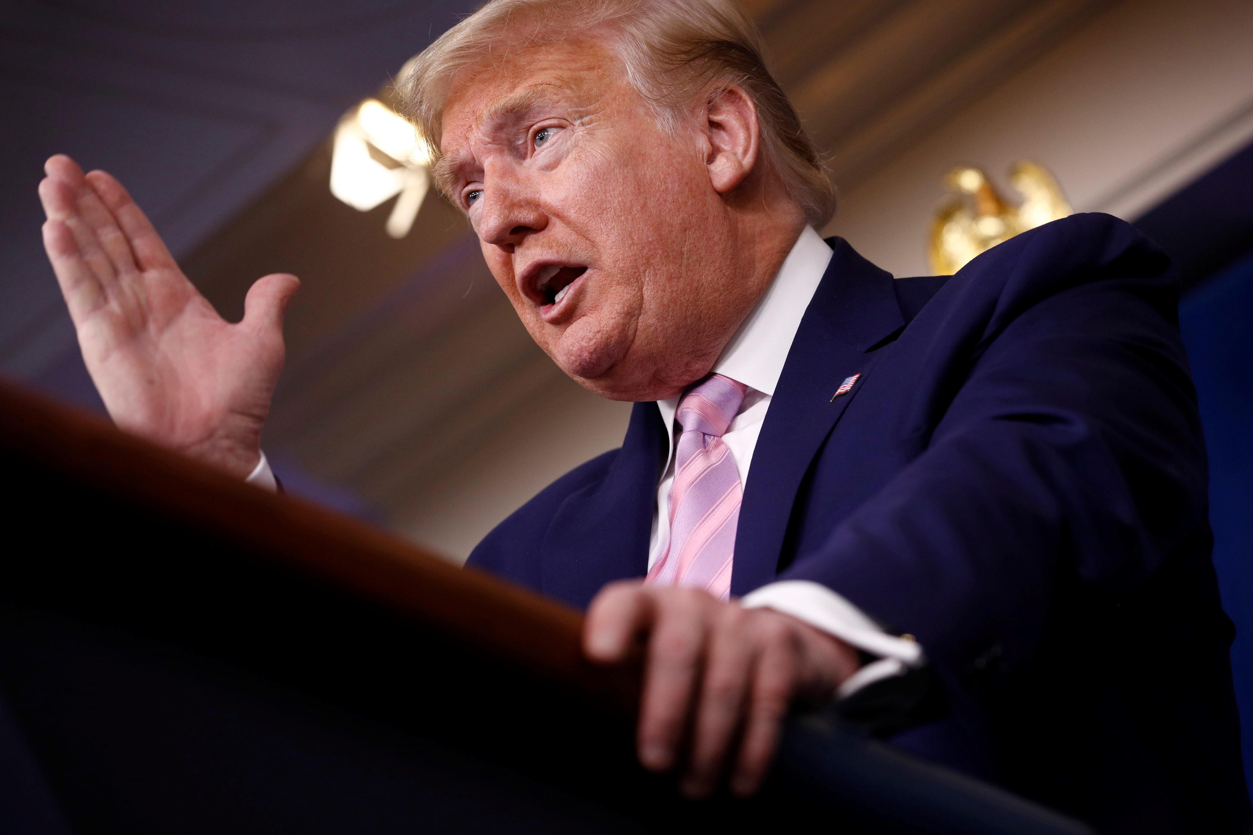 a man wearing a suit and tie: President Donald Trump speaks during a coronavirus task force briefing at the White House.