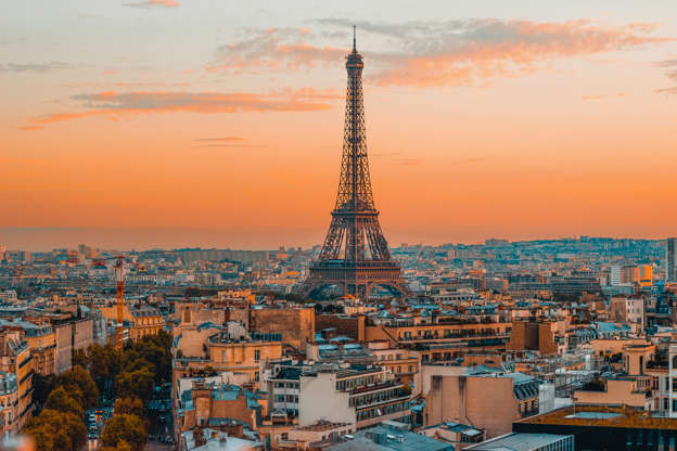 Slide 1 de 65: Breathtaking view of the Eiffel Tower and the serene Paris skyline during a vibrant European sunset, captured from the top of the Arc de Triomphe.