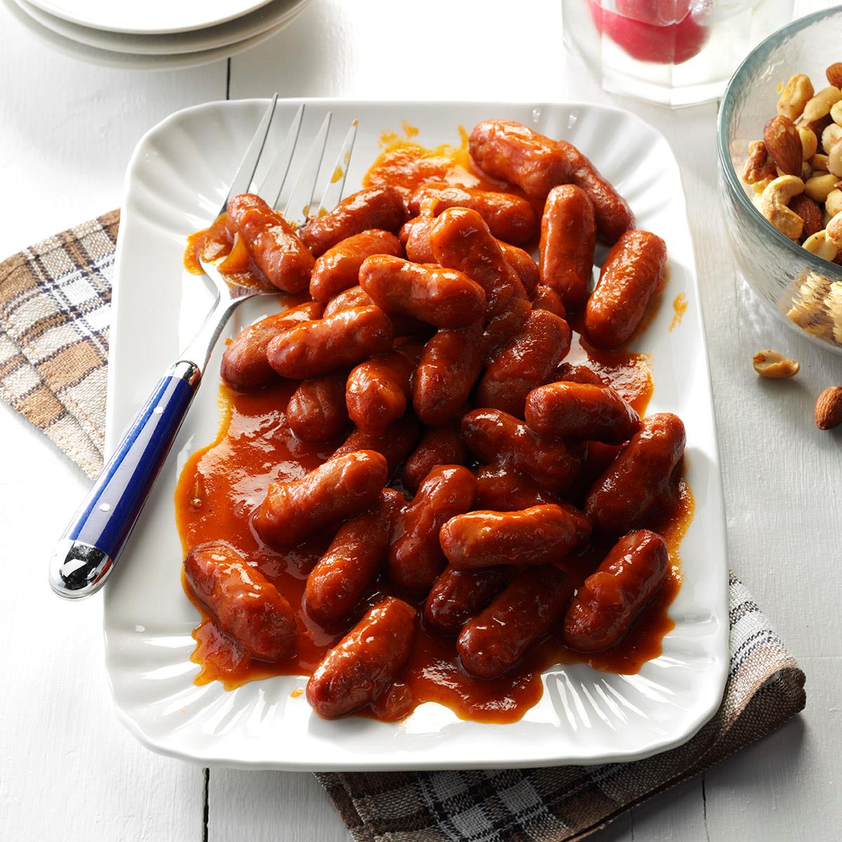 These tiny, tangy appetizers have such broad appeal. I prepare them often for holiday gatherings, weddings and family reunions. They're convenient to serve at parties since the sauce can be made ahead, then just reheated with the franks before serving. —Lucille Howell, Portland, Oregon <a href="https://www.tasteofhome.com/recipes/party-franks/">Get Recipe</a>