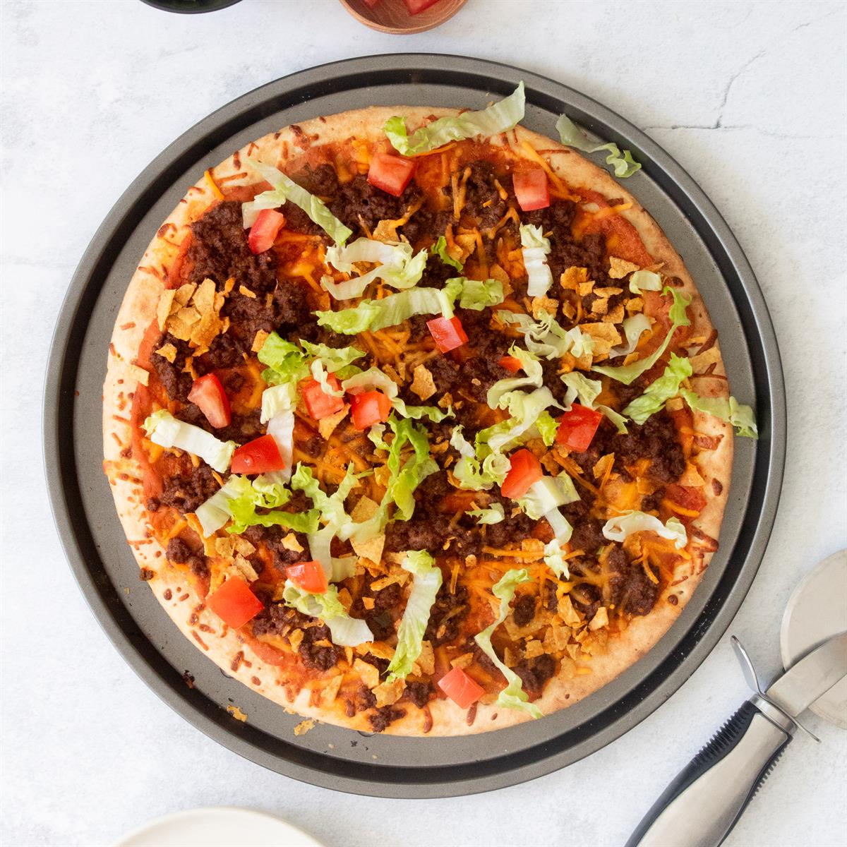 Convenient prebaked crust makes this tasty taco pizza as easy as can be. It's a great recipe, especially if you have teenagers. I keep the ingredients on hand so that we can whip up this filling meal anytime. —Mary Cass, Baltimore, Maryland <a href="https://www.tasteofhome.com/recipes/easy-taco-pizza/">Get Recipe</a>