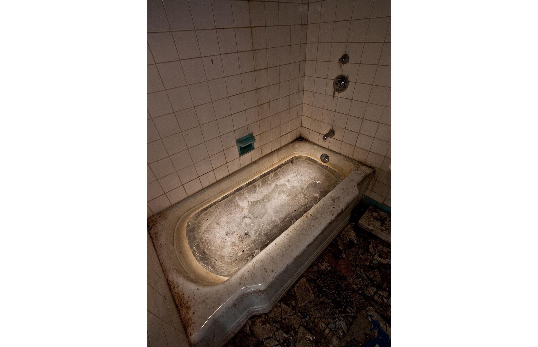 Slide 7 of 70: The hotel closed in 1986 after Grossinger's descendants sold it and has been empty ever since. Inside many features such as this bathroom and the indoor pool are still broadly intact.