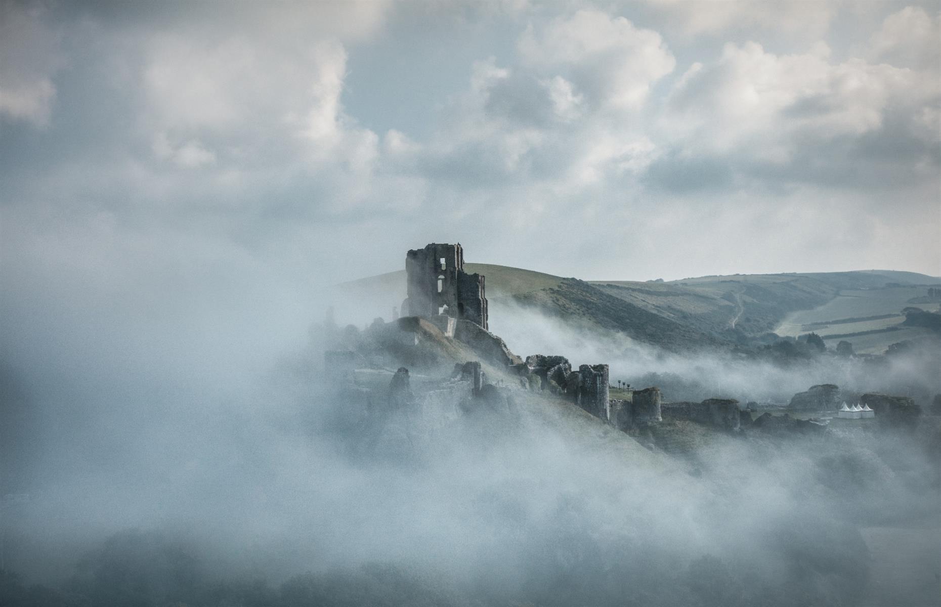 Slide 2 of 29: Corfe Castle, on the Isle of Purbeck in Dorset, has been a romantic ruin on the English landscape for 350 years. Built by William the Conqueror in the early 12th century, it's seen its share of horror. In the 13th century, Bad King John lived up to his name when he starved 22 Frenchmen to death in the dungeons. In 1572, Queen Elizabeth I sold the castle into private hands and it was bought by Sir John Bankes in 1635.