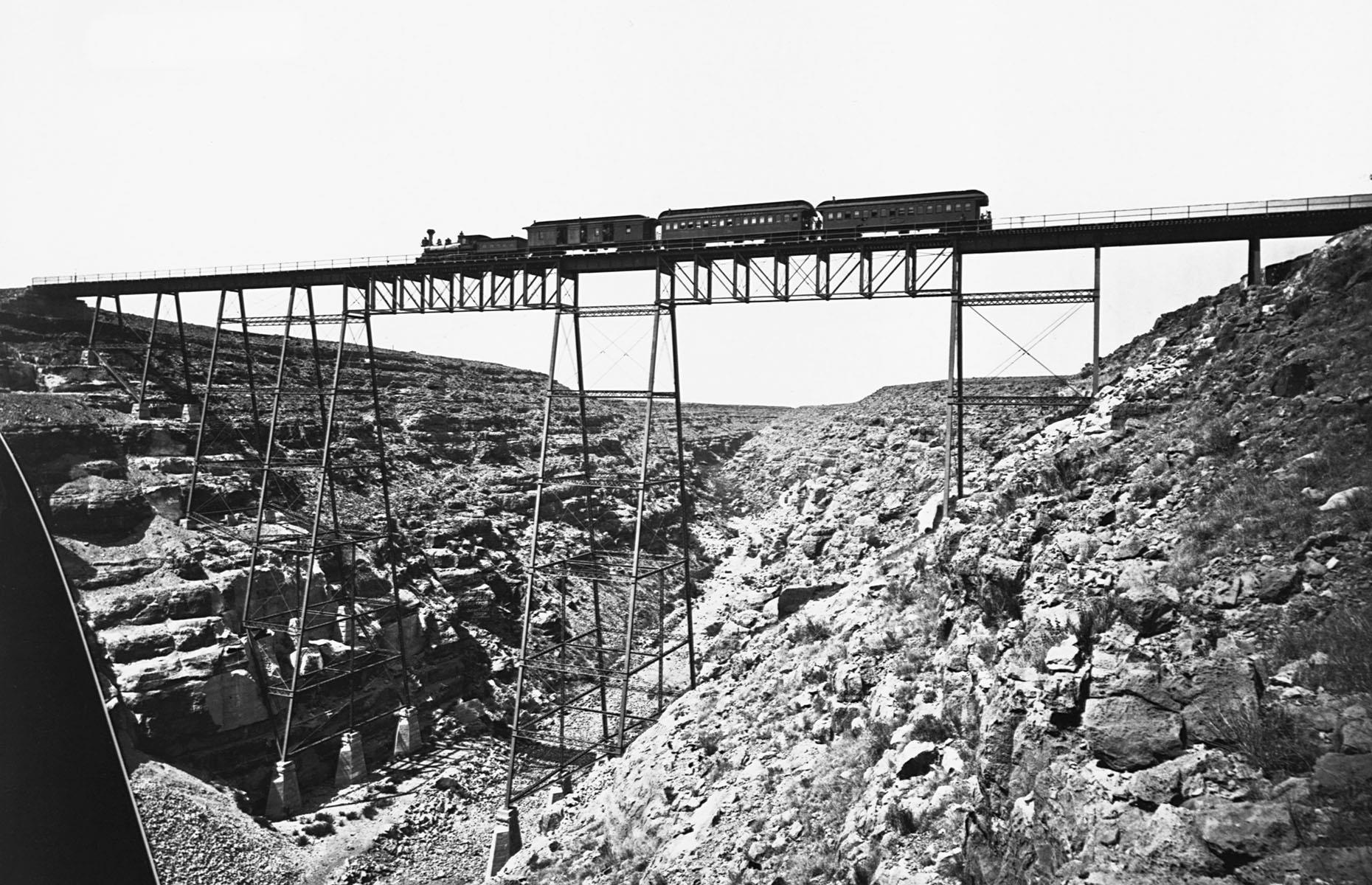 One of the biggest obstacles railroads faced in the early days was traversing the often challenging landscapes. One such place was Canyon Diablo in Arizona – this is the earliest inception of a railroad bridge across the canyon photographed at some point in the 1870s. The current steel bridge was finished in 1903, but the foundations of the original trestle bridge can still be seen today.