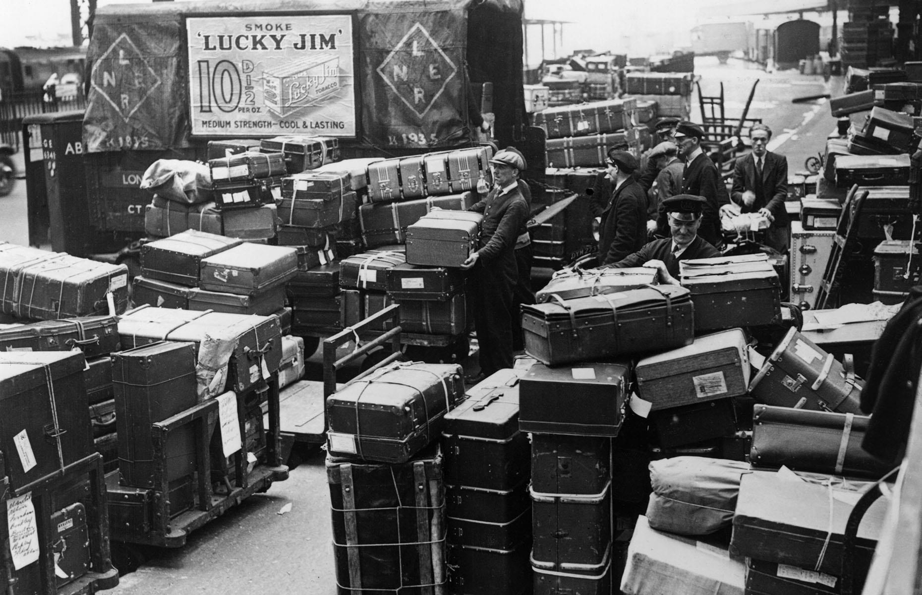 <p>Whether it's train travel in the 1930s or jetting away on an aeroplane in the 2000s, there's still baggage to be loaded and unloaded. Here baggage men unload passengers' suitcases from a train that's arrived at London Waterloo station. <a href="https://www.loveexploring.com/galleries/86315/how-air-travel-has-changed-in-every-decade-from-the-1920s?page=1">Take a look at how air travel has changed in the last 100 years</a>.</p>