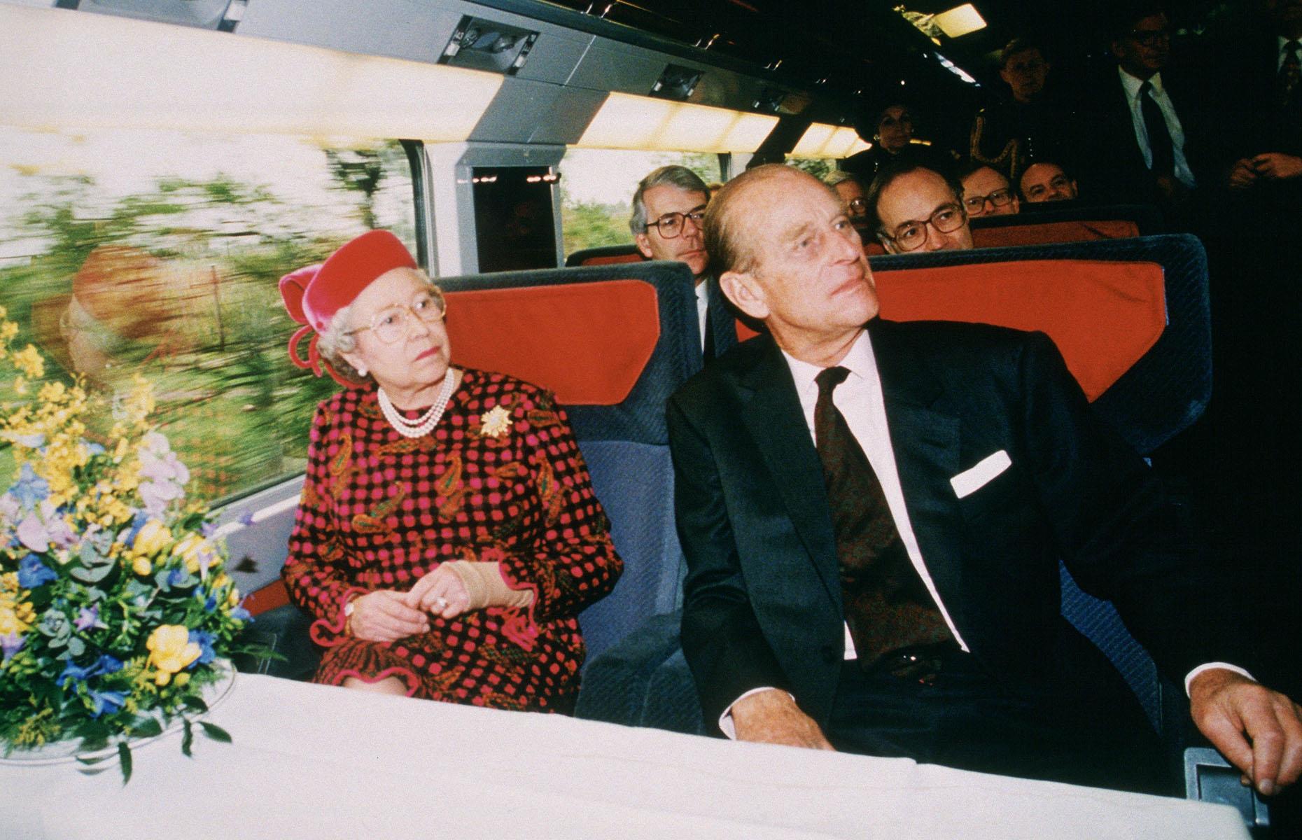 The dream of a tunnel and a train connecting mainland Europe and the UK finally came true in 1994 when both the Eurotunnel and Eurostar were launched. Here, Queen Elizabeth II and Prince Philip are joined by Prime Minister John Major (sitting behind the Queen) aboard a Eurostar train on the inauguration of the tunnel on 6 May 1994.