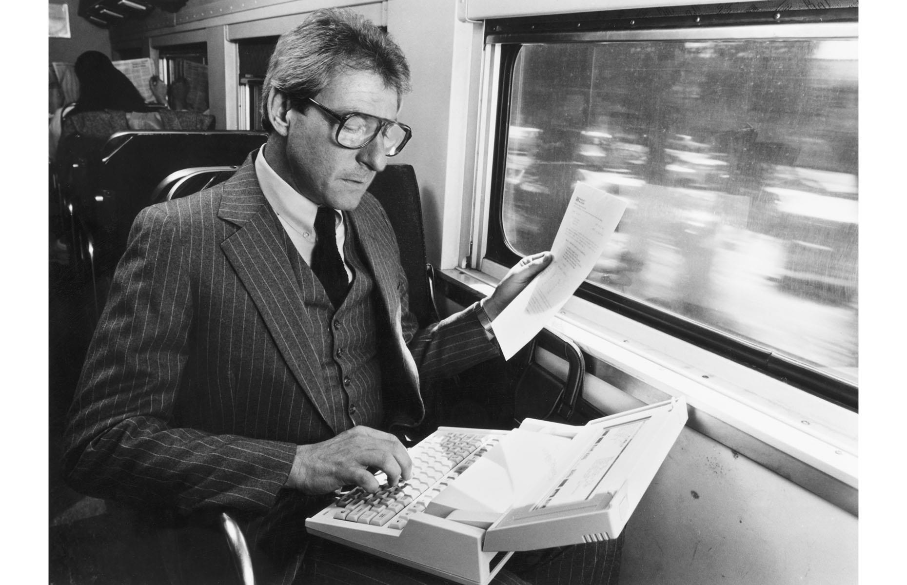 <p>Not at all a surprising sight on any train today, this gentleman from the 1980s is well ahead of his time as he's using precious commute time to do work on an early Hewlett-Packard laptop. Discover <a href="https://www.loveexploring.com/galleries/95350/vintage-photos-of-american-summer-vacations?page=1">vintage photos of American summer vacations</a>.</p>