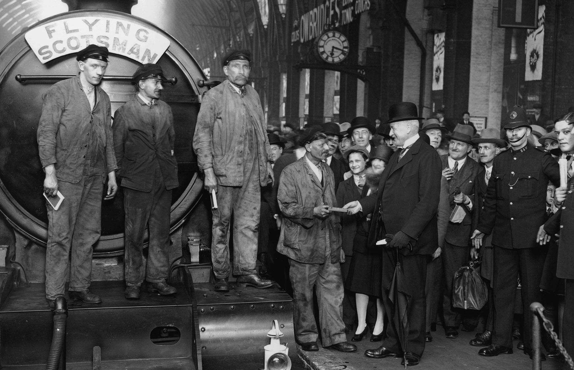 <p>One of Britain's most famous trains, the Flying Scotsman, embarked on its first journey in 1862, however, it wasn't until May 1928 that it completed its first non-stop service between Edinburgh and London. In this image captured at King's Cross Station in London, the train driver and firemen are presented with souvenirs to mark the occasion. This particular locomotive (LNER Class A3 4472) also set two steam locomotive world records, first reaching a speed of 100mph (161km/h) and then for the longest non-stop run of 442 miles (711km) while in Australia in 1989.</p>