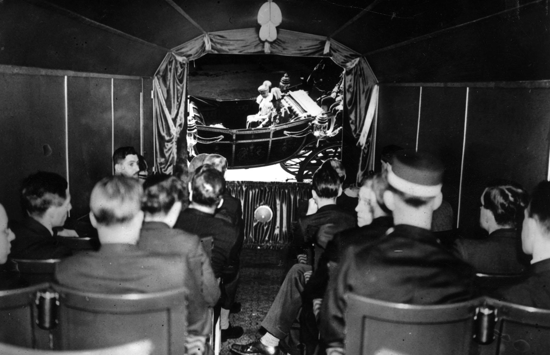 The UK took a similar approach in 1935 when King George V's Silver Jubilee film was shown on board the train departing London King's Cross to Peterborough.