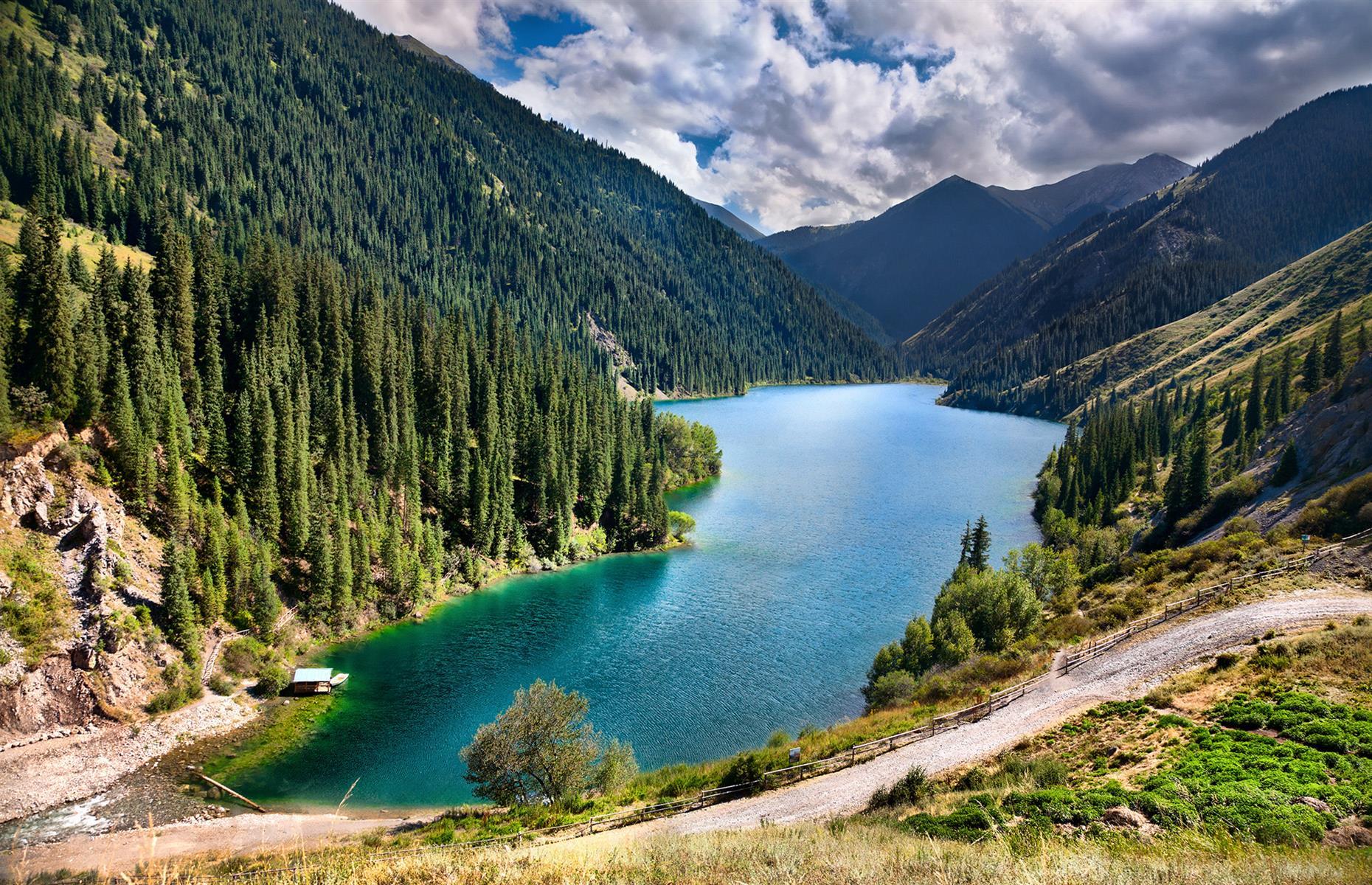 Slide 41 of 44: Spreading out close to the Kyrgyzstan border, the wilderness here is characterized by glassy lakes, green peaks and pastures, with rivers running through thick, untouched forest. It's little wonder that the Kolsai Lakes are often dubbed the "Pearls of Tien Shan". 