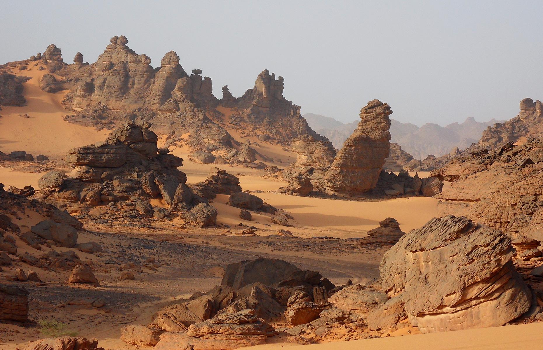 Slide 30 of 44: The Ennedi Plateau is essentially a natural bulwark, with towering rock buttresses, bridges and arches. Sandstone bluffs here soar above 4,756 feet (1,450m) and the stark, otherworldly landscape looks like something straight from a Star Wars film. 