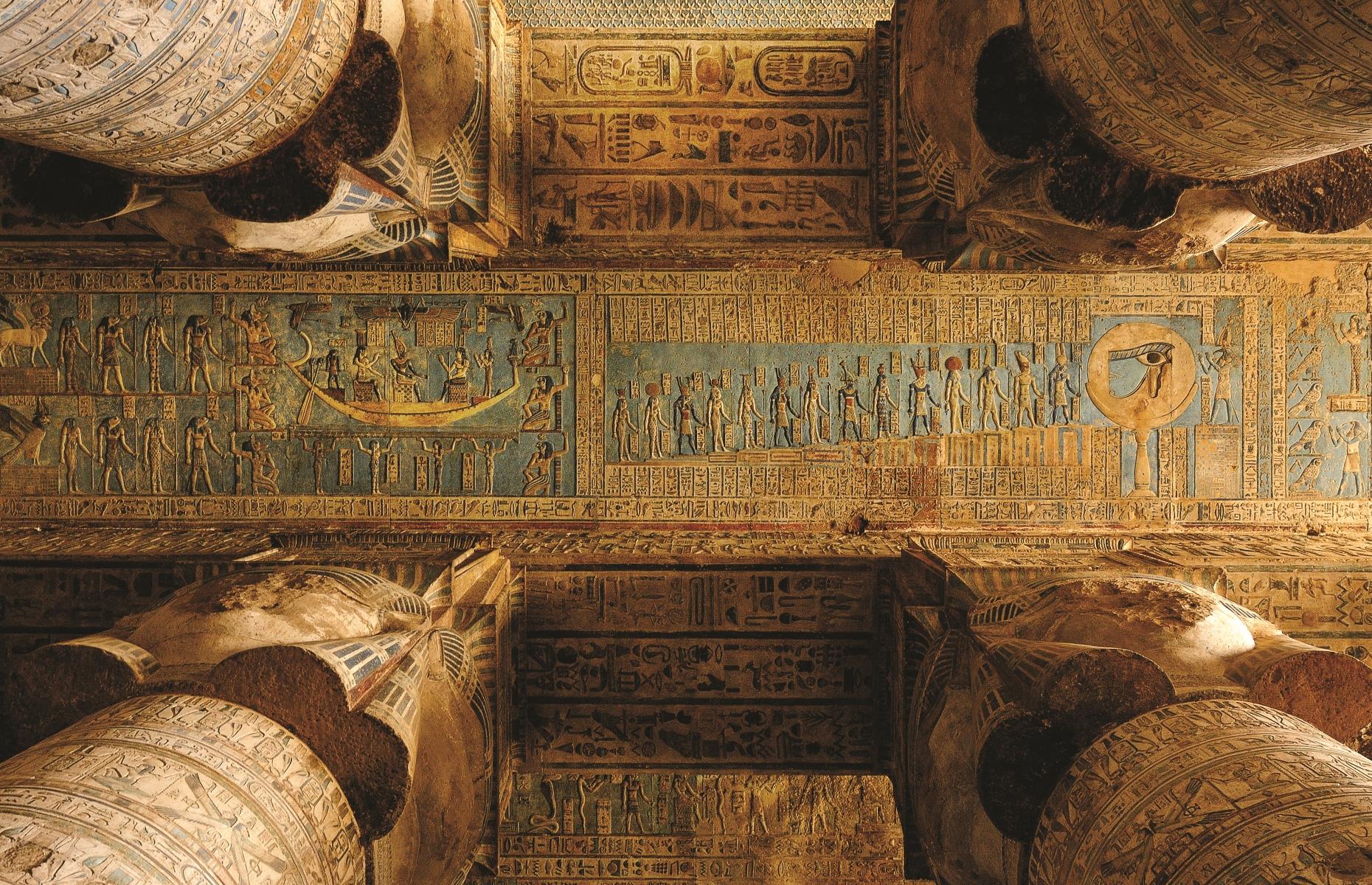 Slide 8 of 14: Another impressive hall exists at the Temple of Dendera, some 40 miles (64km) north of Karnak. Dating to the reign of Emperor Tiberius (AD 14–37), the beautiful outer hall was constructed with 24 columns, each of which had a capital with the face of the goddess Hathor on each of the four sides. The ceiling maps out a symbolic chart of the heavens including the familiar signs of the zodiac, introduced to Egypt by the Romans.