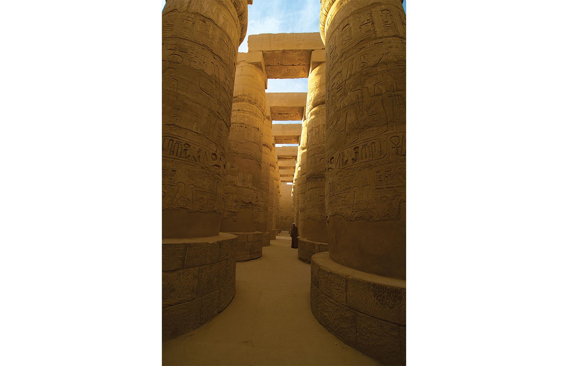 Slide 7 of 14: Nearby is the Karnak Temple Complex, an archaeological site rich in treasures and home to one of the great masterpieces of ancient Egyptian architecture. The Great Hypostyle Hall, a jaw-dropping site filled with intricately carved columns, was the vision of Seti I (1294–1279 BC), another New Kingdom pharaoh. The pillared hall is testament to Seti I’s interest in art, since he was "a rare combination of military leader and connoisseur of the arts". The hall – standing before the innermost shine complex of Amun-Re, god of the sun – was intended to represent the primeval swamp land that emerged at the creation.