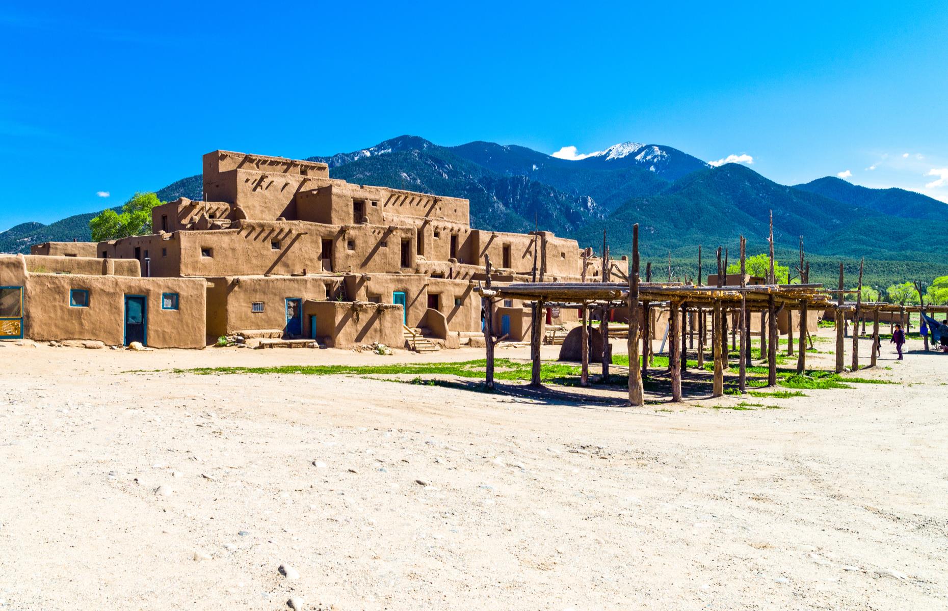 <p>This New Mexico pueblo has been inhabited by indigenous people for more than 1,000 years and is still home to around 150 villagers. The stacked, adobe structures are overlooked by the beautiful Sangre de Cristo Mountain range, their terracotta façades broken up with splashes of blue. Guided tours are usually available but the village – three miles (5km) north of Taos city – is currently closed to visitors. <a href="https://taospueblo.com/visiting-taos-pueblo/">Check the website</a> for updates and availability.</p>