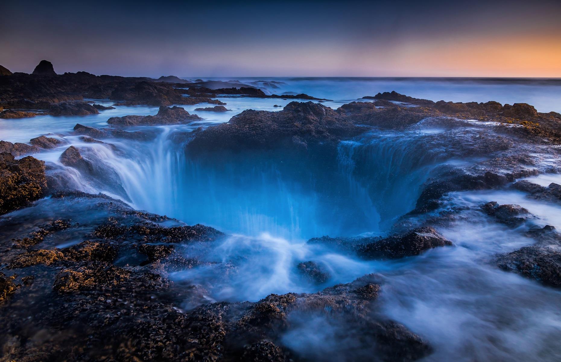 Slide 43 of 59: Nicknamed the drainpipe of the Pacific, Thor's Well appears to be stealing water from the sea itself. The natural sinkhole is nestled on the coast of Oregon, close to Cape Perpetua, and is thought to have started out as a sea cave that eventually collapsed into itself. Thought to be around 20 feet (6m) deep, the hole becomes even more mesmerizing at high tide or during intense storms when water violently thrashes over the rocks. Discover more mysterious places around the world here.